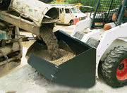 Ready-mix truck chute loading concrete into the placement bucket on a skid steer