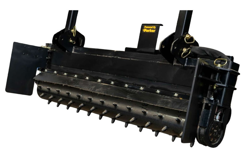 Power rake drum from the front showing the carbide teeth set in a spiral along its length