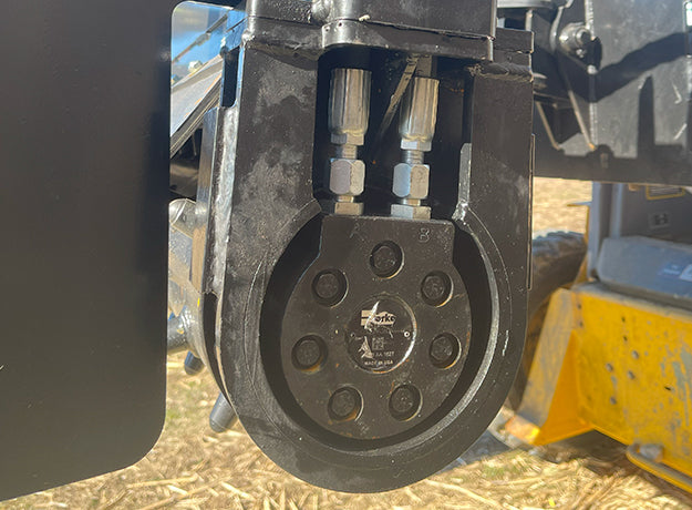 Close-up of the power rake drive end showing the drive coupling behind the side plate