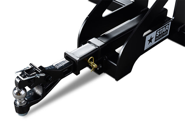 Close-up of the trailer spotter's square receiver tube with the pinned hitch adapter and the Star Industries badge