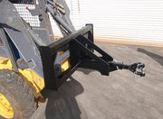 Trailer spotter on a skid steer at ground level, showing the frame's flat foot resting upright on the pad