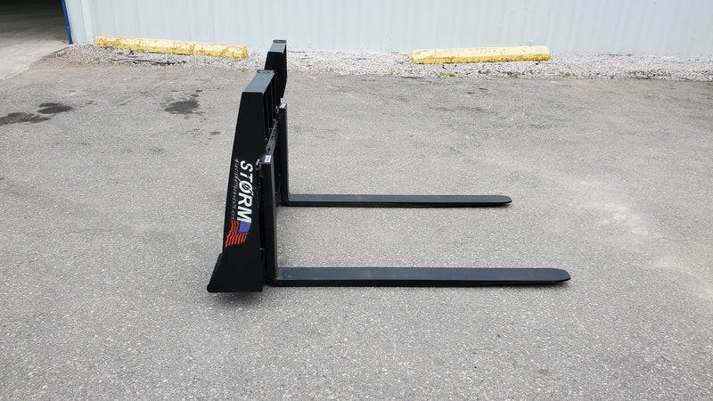 Storm 4500 pallet forks on pavement, side view showing the frame and fork blades
