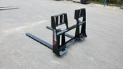 Storm 4500 pallet forks in John Deere green on wet pavement, angled view of the frame and both tines