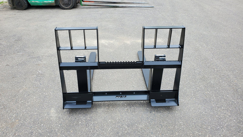 Storm 4500 pallet forks in black on pavement, angled view showing the tall frame and the carriage rail