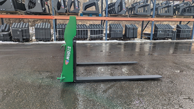 Storm 4500 pallet forks in John Deere green, side view showing the upright and the tine reach