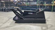 Storm 60 inch brush cutter from the side in a warehouse, showing the deck skirt, brush guard, and hose routing