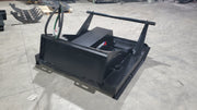 Storm 60 inch brush cutter on a shop floor, angled view of the deck, the drive housing and the push bar