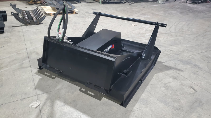 Storm 60 inch brush cutter on a shop floor, angled view of the deck, the drive housing and the push bar