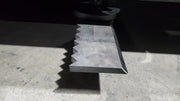 Storm 72 inch HD brush cutter blade, close view of the serrated back edge and the ground cutting edge