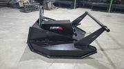 Storm 72 inch HD brush cutter from the side on a shop floor, showing the deck skirt, shroud hinge, and side push bar