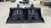 Storm HD grapple bucket on a shop floor, front view with the clamp raised over the open bucket