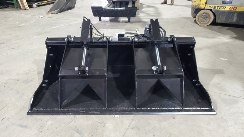 Storm HD grapple bucket on a shop floor, front view with the clamp raised over the open bucket