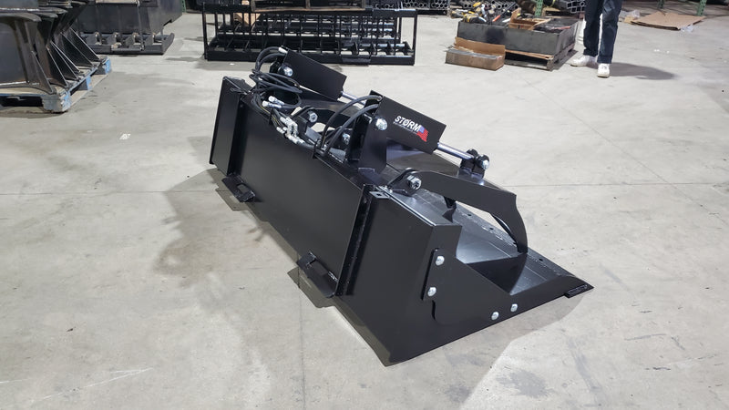 Storm HD grapple bucket on a shop floor, three-quarter view of the bucket and clamp