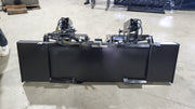 Storm HD grapple bucket seen head-on, showing the cutting edge, bucket, and dual clamp cylinders