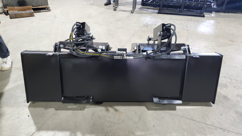 Storm HD grapple bucket seen head-on, showing the cutting edge, bucket, and dual clamp cylinders