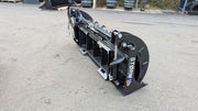 Storm HD rake and brush grapple on pavement, side view showing the rear cylinders and closed clam