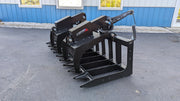 Storm HD root and brush grapple beside a building, angled view of the arms closed onto the tine bar