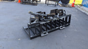 Storm HD root and brush grapple viewed head-on across the full width of the tine bank and clamp