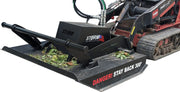 Storm 48 inch mini brush cutter on a Toro Dingo track loader outdoors, with cut brush lying on the deck