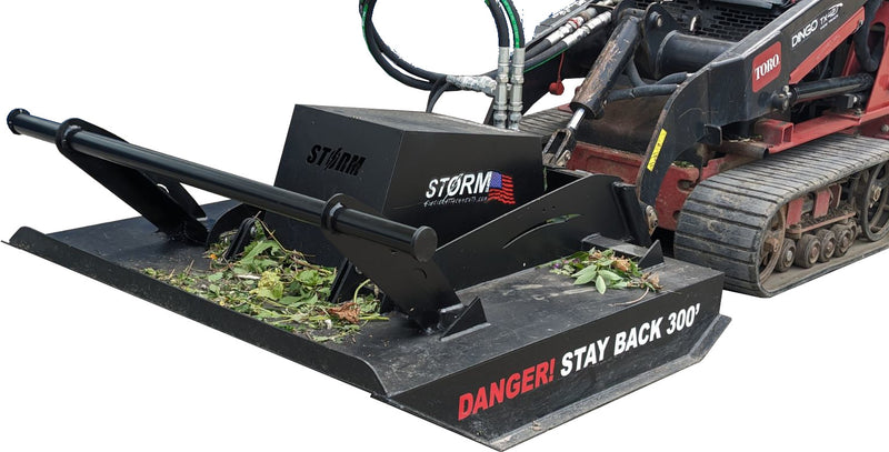 Storm 48 inch mini brush cutter on a Toro Dingo track loader outdoors, with cut brush lying on the deck