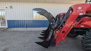 Storm 48 inch rake and brush grapple raised on a red tractor loader, side view of the curved arm over the tines