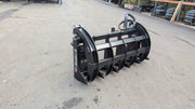 Storm two-cylinder rake and brush grapple on pavement, angled view of the closed clam and cylinders