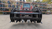 Storm 60 inch two cylinder rake and brush grapple on a red tractor loader, head-on view with the arms closed
