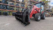 Storm 60 inch two cylinder rake and brush grapple on a red tractor loader, three-quarter view of the arms over the tines