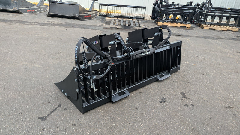 Storm rock and brush grapple on pavement, three-quarter view of the bolted side plates and tine frame