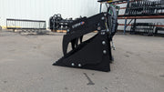 Storm rock and brush grapple on pavement, angled view with the spiked tines facing forward