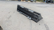 Storm rock bucket on pavement, angled view with the tines facing forward