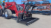Storm root and brush grapple on a red tractor loader, tilted forward with the tines lowered toward the ground