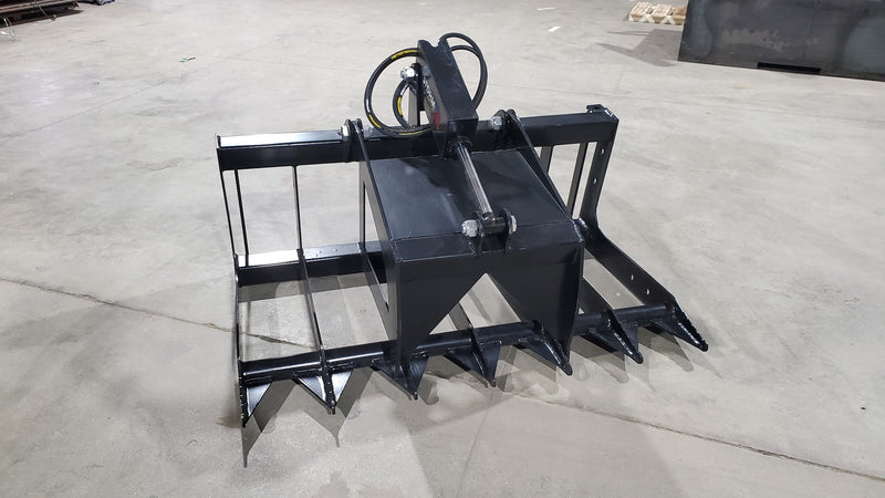 Storm two-cylinder root and brush grapple, three-quarter view showing the frame, tines, and dual cylinders