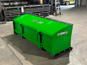 Storm snow pusher in John Deere green on pavement, showing the boxed pusher on the John Deere mount