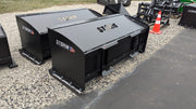 Storm box snow pushers on a gravel yard, three-quarter view of the enclosed moldboards