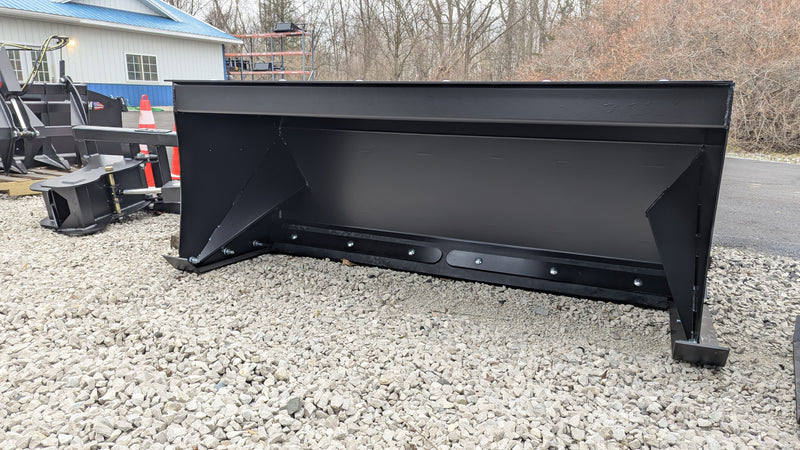Storm box snow pusher on gravel, side view of the moldboard and boxed sides