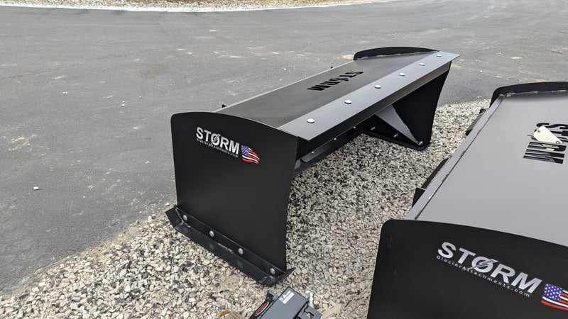 Storm snow pusher, close view of the back-drag bar and the bolted cutting edge along the base