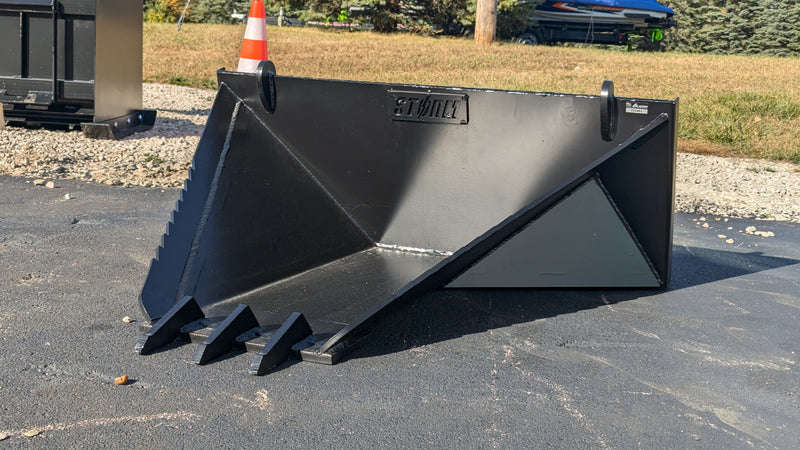 Storm stump bucket on gravel, three-quarter view of the V-body and serrated top