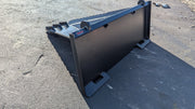 Storm stump bucket on pavement, side view of the tapered body and quick-attach plate
