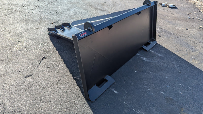 Storm stump bucket on pavement, side view of the tapered body and quick-attach plate