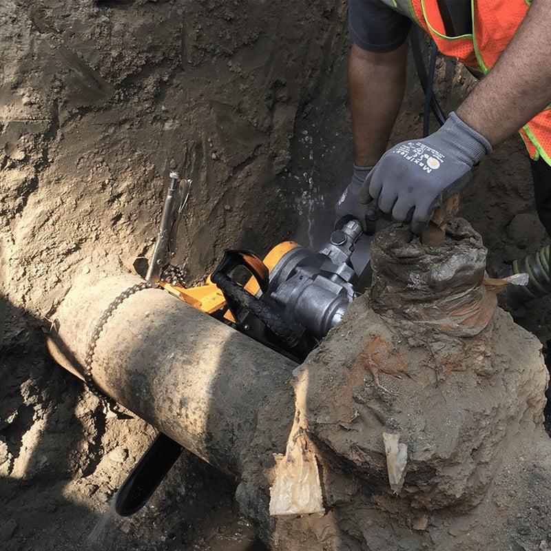 Operator cutting an exposed main with the ACH-GB