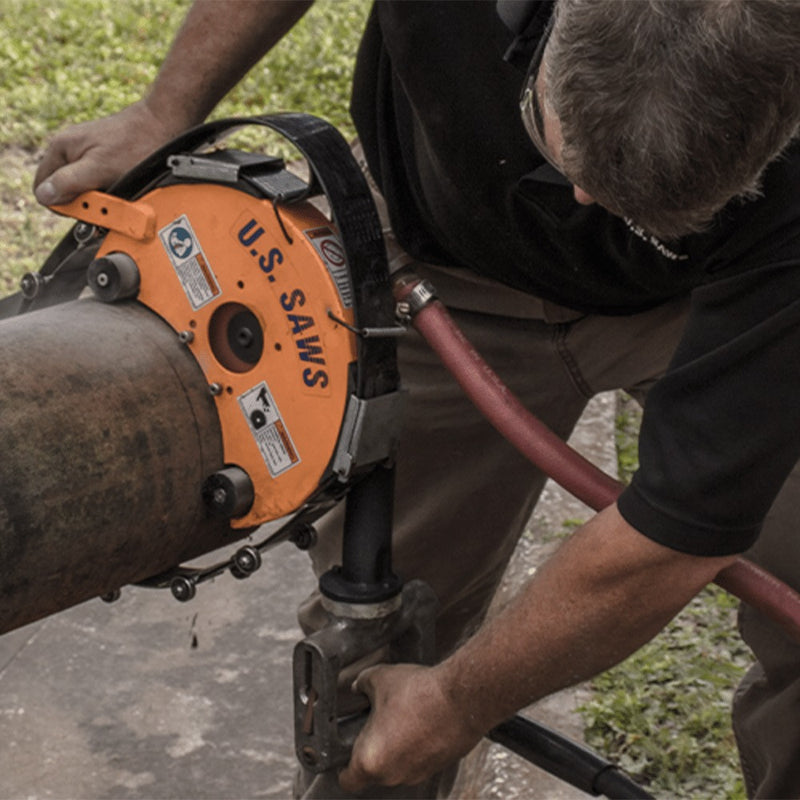 Operator cutting a pipe underside in the trench with the air belly saw