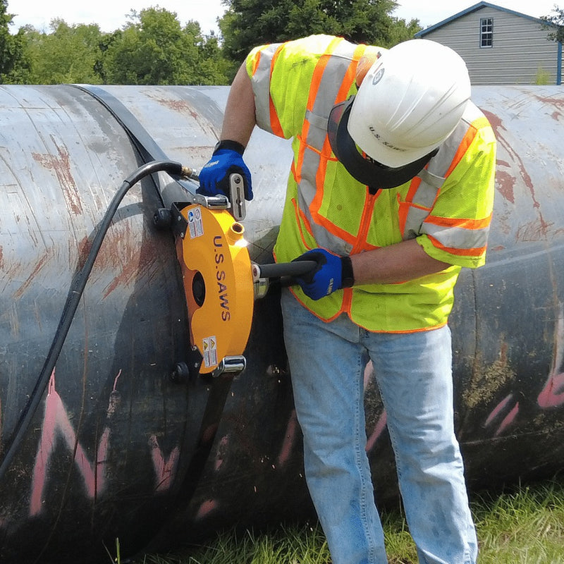 Operator finishing a circumferential cut on large pipe with the Big Belly saw