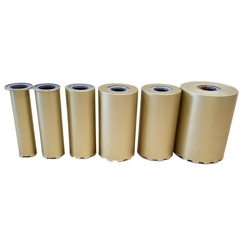 Six gold core barrels standing on end in ascending diameter, each open at the top with a steel ring set in the mouth and a segmented cutting crown at the base