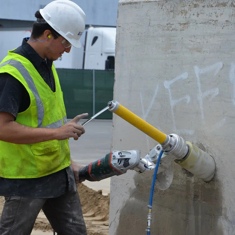 Operator core drilling a wall with the Core EZ