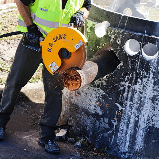 Operator cutting pipe in an excavation with the HS air saw
