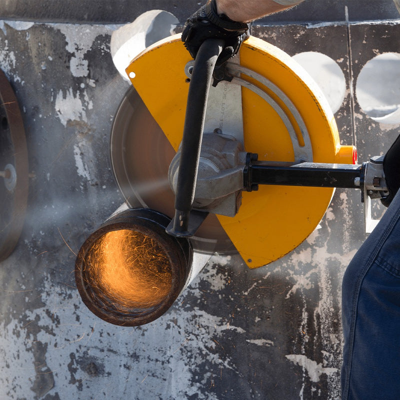 HS air saw wet cutting a pipe at close range