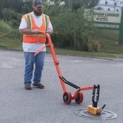 Operator rolling a cover on the curved steel dolly