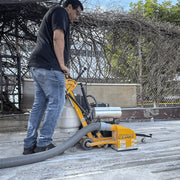 Operator milling a floor joint outdoors with the MC-800 and dust hose attached