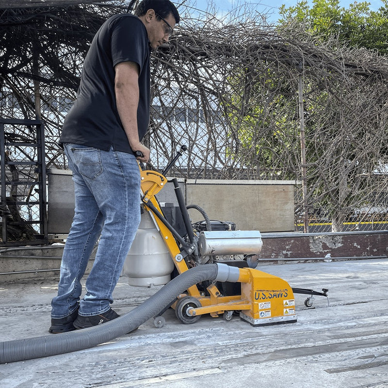 Operator milling a floor joint outdoors with the MC-800 and dust hose attached